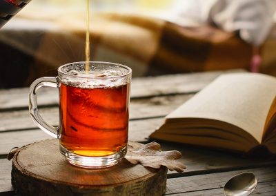 Herbal tea in glass cup in cozy ambience.